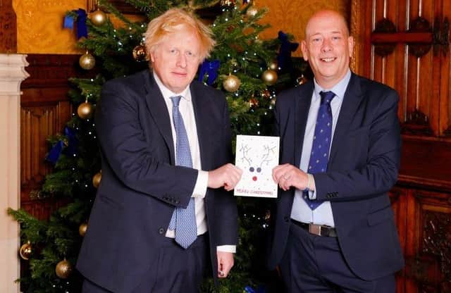 Mark Eastwood presenting last year's winning Christmas card to the then prime minister Boris Johnson.