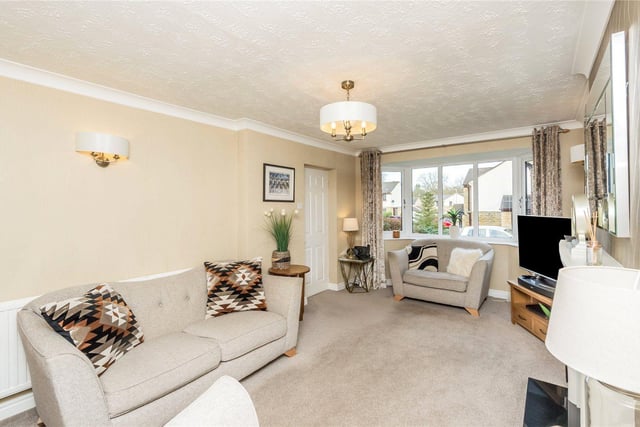 This spacious lounge features a fireplace and living flame gas fire as well as double glazed doors to the dining room.