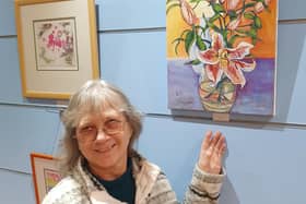 One of the organisers, Dilys Beaumont with one of the pieces of artwork donated by Carol Curtis.