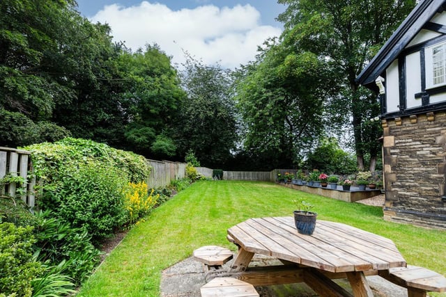 Established trees, plants and shrubs create interest in the property's attractive gardens