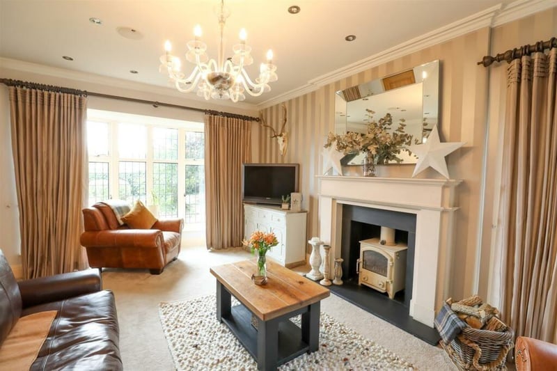 This generously sized reception room includes a large front facing bay window and a wood burning stove.