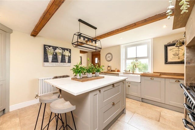 The well-appointed kitchen which has fitted units, centre island and a number of integrated appliances plus a Rangemaster double oven with gas hob.
