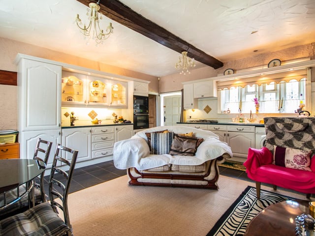 The beamed kitchen has flexible space and plenty of natural light.