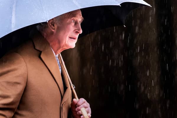 King Charles III shelters from the rain beneath an umbrella during a visit to York Minster last November. His coronation day on Saturday May 6, is forecast to be another wet day, according to the Met Office. Photo by DANNY LAWSON/POOL/AFP via Getty Images