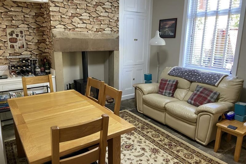 The dining and sitting room has a stone flagged floor with a cosy woodburning stove.