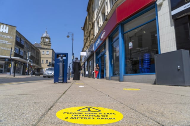 A reminder in Dewsbury reads 'Please keep a safe distance of two metres apart', encouraging the public to practise social distancing as 'non-essential' shops in Dewsbury reopen for the first time since the national lockdown of March 2020. Picture: Scott Merrylees