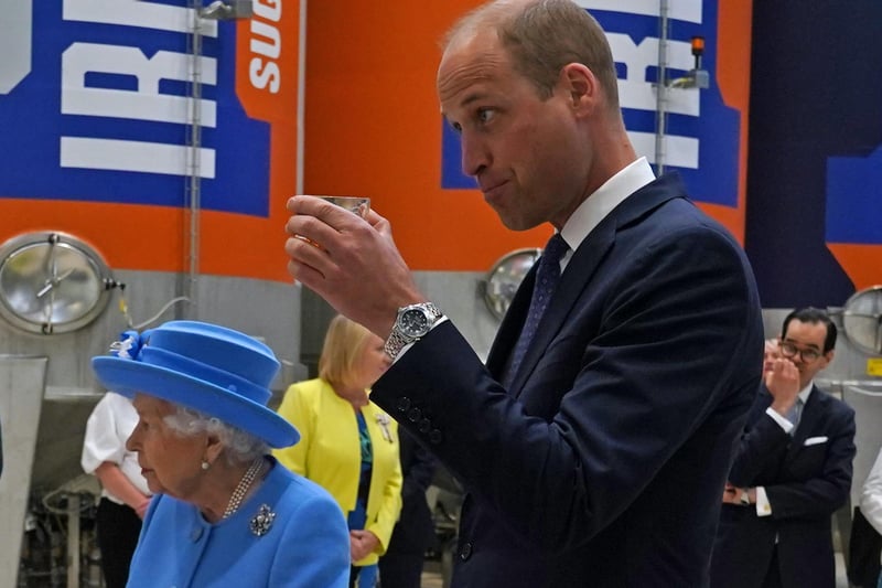 The Duke of Cambridge, known as the Earl of Strathearn in Scotland, tries Irn-Bru as Queen Elizabeth II looks on,.