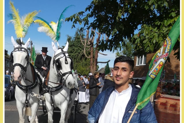 Bilal Malik at the Ravensthorpe Eid-Milad Peace Procession, holding a green Sufi-Muslim flag.