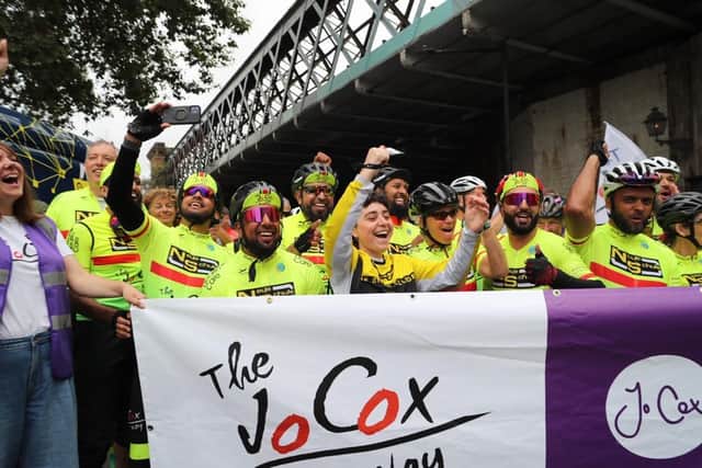 Cyclists from The Jo Cox Way celebrate at the finish line of their epic 288-mile ride from Cleckheaton to London. (Photo credit: Steve Fox)