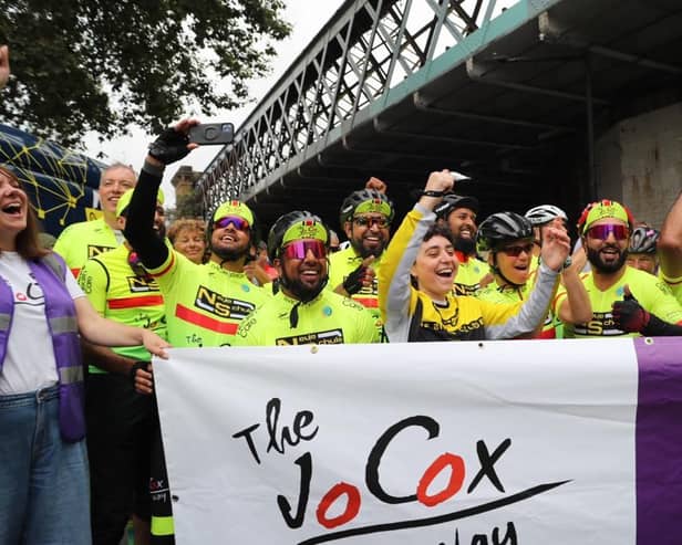 Cyclists from The Jo Cox Way celebrate at the finish line of their epic 288-mile ride from Cleckheaton to London. (Photo credit: Steve Fox)
