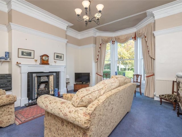 The period fireplace is a focal point in this reception room.