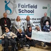 Fairfield School in Batley has received a £15,000 donation from St John’s Masonic Lodge in Dewsbury. Pictured are Sarah Breeze, fundraiser at Fairfield, John Page, headteacher at Fairfield, Steve Walsh, school business manager, Sue France and Karen Kirk, and John Hudson, charity steward of St John’s Masonic Lodge Dewsbury, as well as pupils from Fairfield.