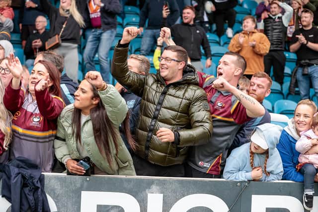 Batley fans celebrate the team's victory at Featherstone Rovers. Main sponsors of the club, Kay Sheldon of K&M Metals, says their progress to the Million Pound Game on Sunday against Leigh is "a dream come true for the players, the staff and the fans."