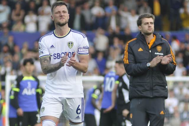 Liam Cooper and Patrick Bamford applaud the Leeds United fans who stayed at Elland Road to the end.