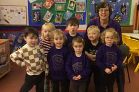 Janet Bolt, manager at Roberttown Lane Pre-School, celebrates the settings' good Ofsted report with some of the children.