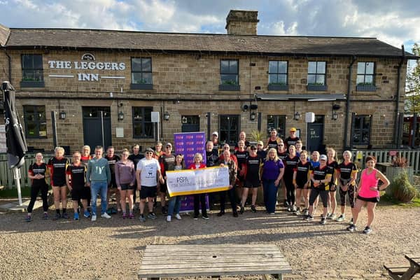 The Dewsbury Road Runners present a cheque to PSPA