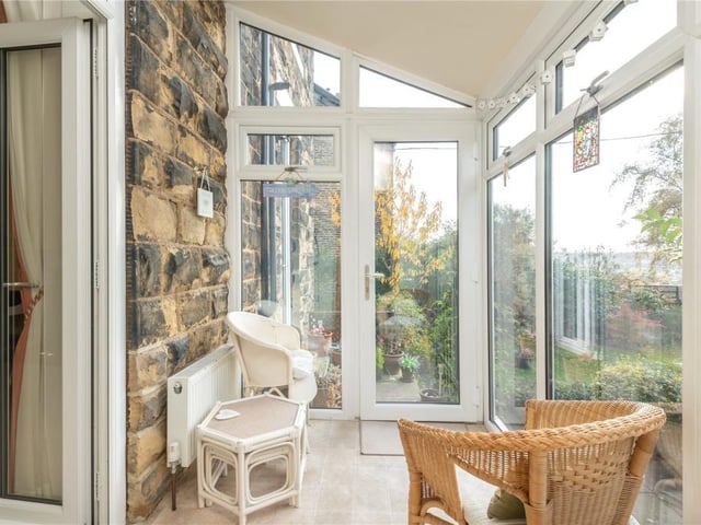 The conservatory looks out over the garden, with wider views beyond, and has a door leading outside.