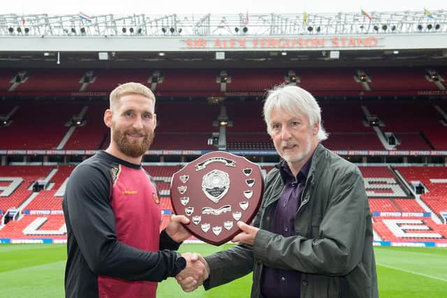 Catalan Dragons' Sam Tomkins is awarded the Rugby League Writers and Broadcasters Association Player of the Year award by Ian Laybourn, right, at Old Trafford in 2021