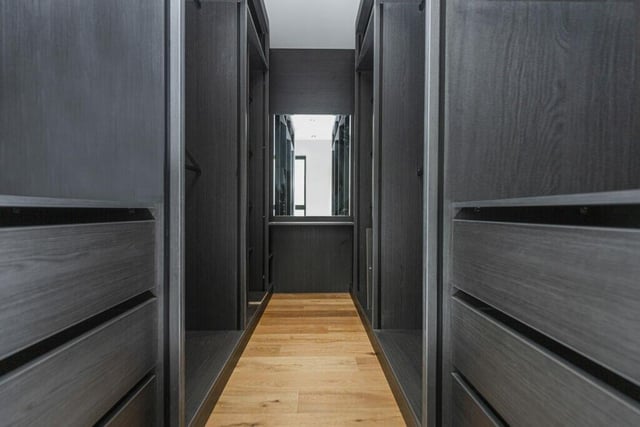 The master bedroom suite has a walk in dressing room with wardrobes.