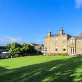 A rear view of the attractive Ossett property and its extensive lawned garden.