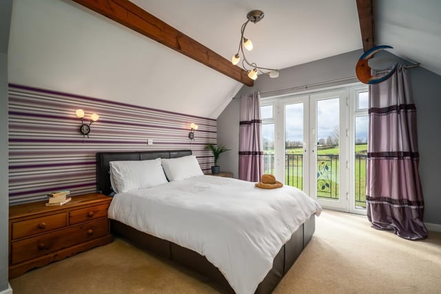 This double bedroom has built-in wardrobes, and French doors out to a balcony.