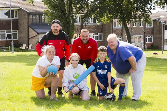 Shaw Cross Community Centre summer holiday activities for kids. Back, from the left, Danny Teale and Shaun Fox from Legacy Sport and Dave Hilton from Shaw Cross Tenants and Residents Association. Front, Matilda Bolton, 11, Chloe Hilton, 15, and Jaxon Senior, 11.