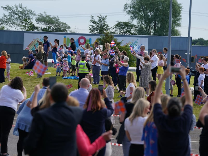 Crowds gather to greet Queen Elizabeth II and the Duke of Cambridge.