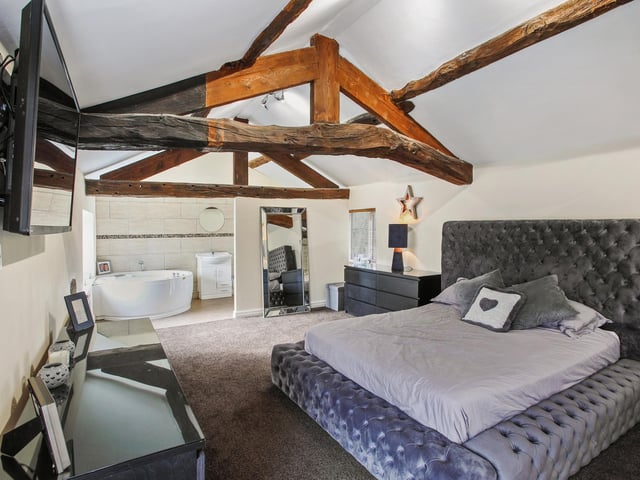Open beams and an en suite facility form part of this character room.