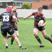 Shaw Cross Sharks came up with a crucial victory over Dewsbury Moor Maroons in their race for promotion with their derby rivals.