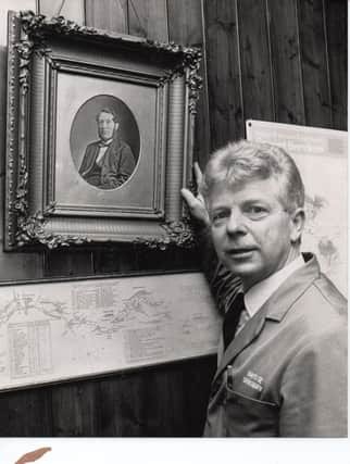 Pictured some years ago is a young Charles Day when he worked in the family business founded by his ancestor Henry Day, whose picture hangs on the wall.