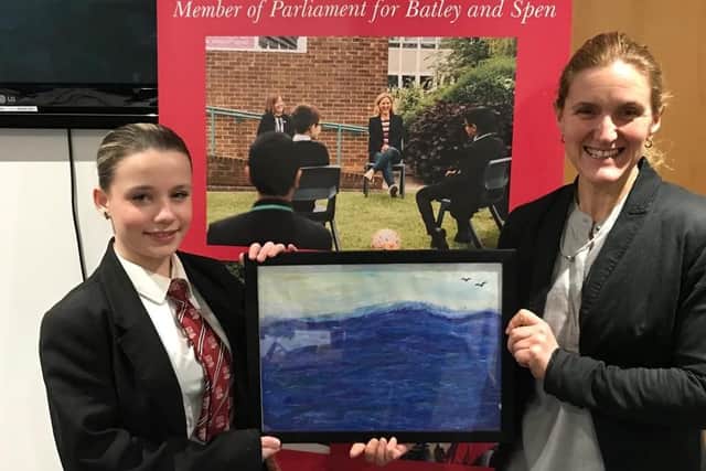 Talented artist, Tilly Cardle, presenting her 'Together' painting to Batley and Spen MP Kim Leadbeater