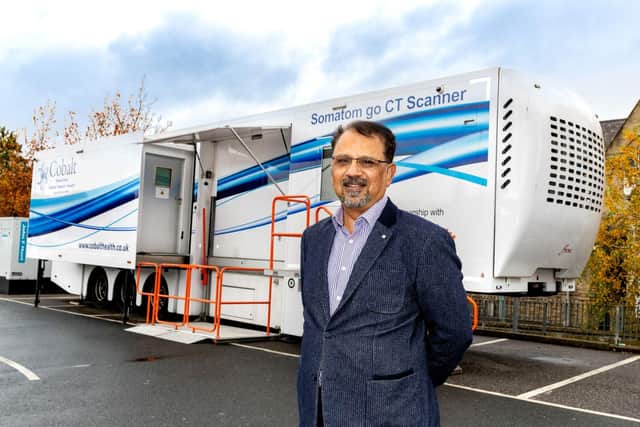 Dr Khalid Naeem, GP and chair of Kirklees clinical and professional forum, outside the mobile CT scanner.