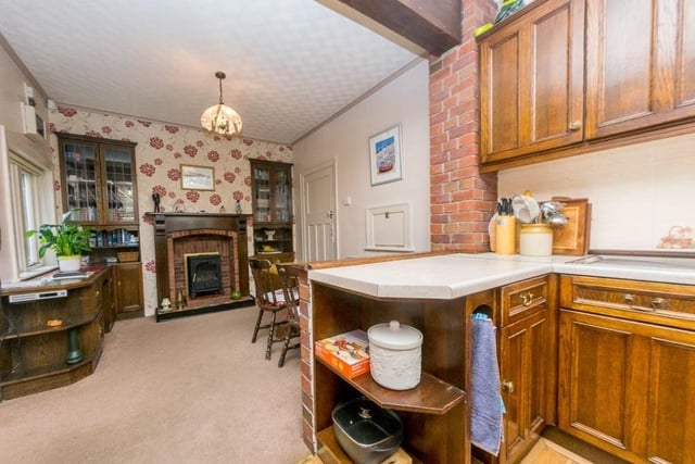 The breakfast room, with stove and fireplace, is open plan to the kitchen.