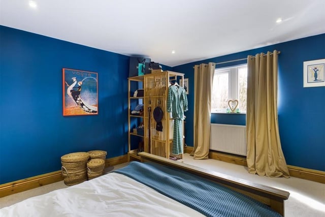 A carpeted bedroom which demonstrates size and space.