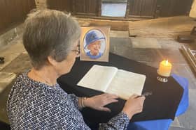 Tineke Bentley signing the book of condolence at All Saints’ Parish Church in Batley.