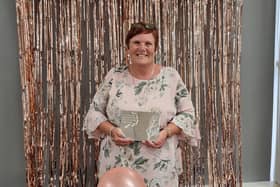 Mandy Farrar, safeguarding and wellbeing officer at Diamond Wood Community Academy, with her Silver Award for Unsung Hero , from The Pearson National Teaching Awards.