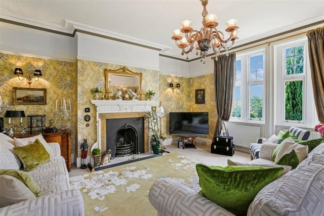 A stunning fireplace and sash windows, with period decorative detail are features of this reception room.