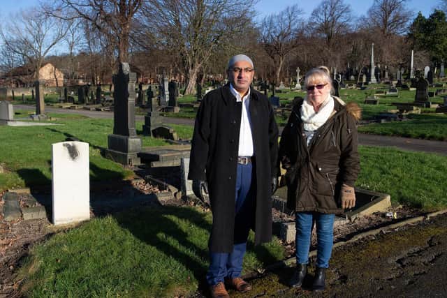 Mohammed Javed and Christine Leeman, next to the damaged war grave at Dewsbury Cemetery