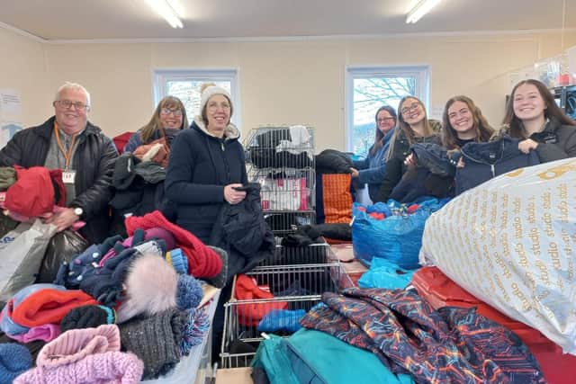 Uniform Exchange founder Kate France (third right) and volunteers sorting our clothes for Kirklees s