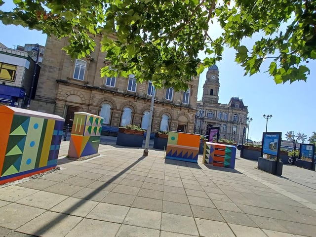 Artwork on stat boxes and new planters in Dewsbury town centre.