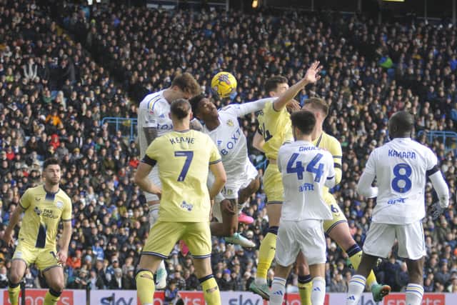 Leeds United defenders Joe Rodon and Junior Firpo climb highest to head the ball.