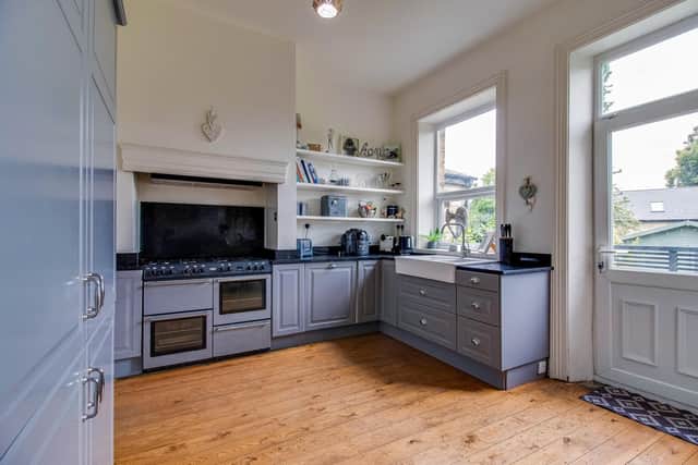 The spacious kitchen with fitted units and granite worktops, integrated appliances and a range cooker.