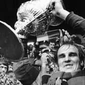 Dewsbury's Mick Stephenson holds the Rugby League Championship trophy aloft in 1973.