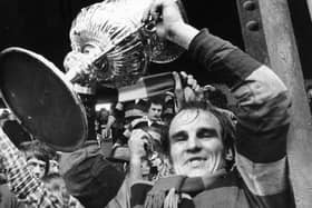 Dewsbury's Mick Stephenson holds the Rugby League Championship trophy aloft in 1973.