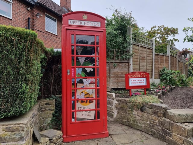 The village’s famous red telephone box, which was bought by the community for just £1.