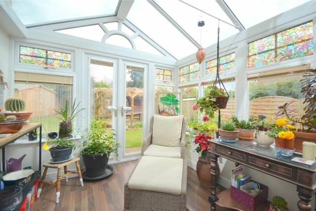 Patio doors lead out to the attractive gardens from the conservatory.