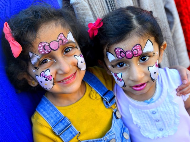 Laaibah Mobeen and Zainab Zaheer with their faces painted.