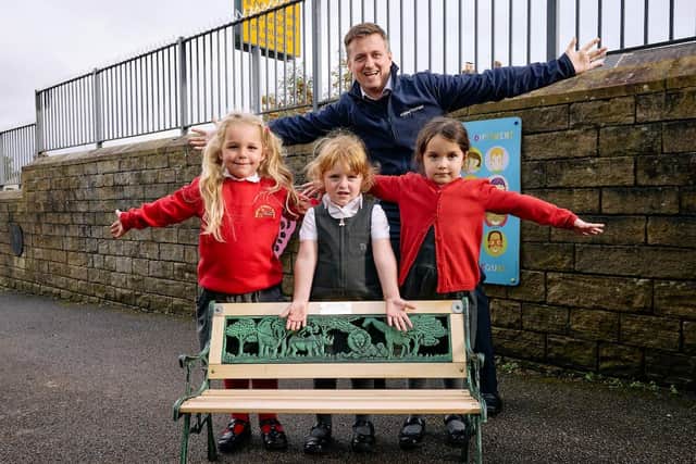 Foundation Unit pupils at Hopton Primary School, Mirfield, enjoy their new ‘Buddy Bench’ and are pictured with Chris Carlin of Miller Homes Yorkshire. (Photo credit: Shaun Flannery)