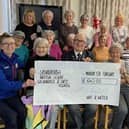 Ken Moran, a representative of the Spenborough Royal British Legion, receiving a cheque from Jean McCulloch who organised the fundraising for the Knit and Natter group in Liversedge.