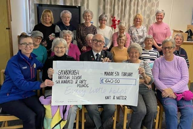 Ken Moran, a representative of the Spenborough Royal British Legion, receiving a cheque from Jean McCulloch who organised the fundraising for the Knit and Natter group in Liversedge.